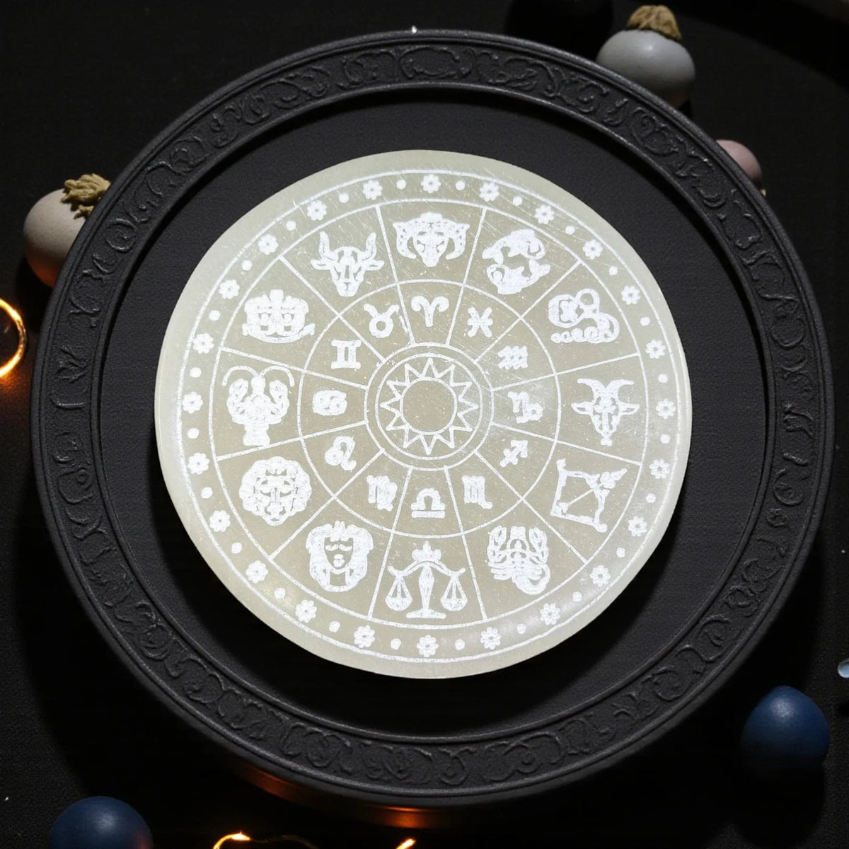 Round black zodiac charging plate with engraved wheel