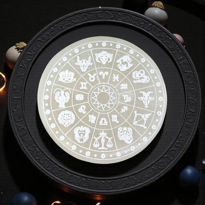 Round black zodiac charging plate with engraved wheel