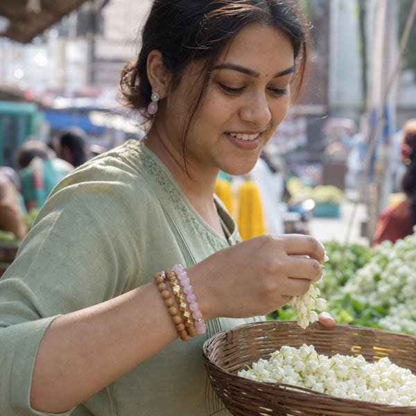 Rose Quartz and Rosewood Bracelet Stack Set of 3 worn by an Indian woman - candid lifestyle photograph