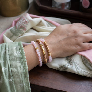 Rose Quartz and Rosewood Bracelet Stack Set of 3 on an Indian womans wrist - realistic close-up lifestyle photo