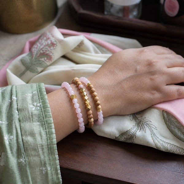 Rose Quartz and Rosewood Bracelet Stack Set of 3 on an Indian womans wrist - realistic close-up lifestyle photo