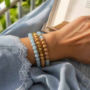 Aquamarine and Rosewood Crystal Bracelet Stack Set of 3 on an Indian woman's wrist - serene lifestyle photo