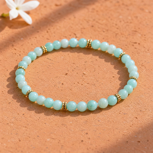 Soultheory Amazonite 4mm Bead Bracelet with Gold Spacers on a terracotta tile with jasmine