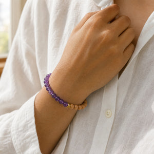 Woman wearing the Amethyst & Rosewood 6mm Bead Bracelet with a white linen shirt