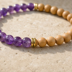 Close-up of the Amethyst & Rosewood 6mm Bead Bracelet on a pale stone surface