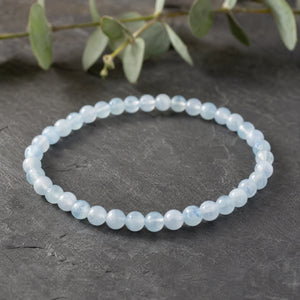 Soultheory Aquamarine 4mm Round Bead Bracelet on dark slate with eucalyptus