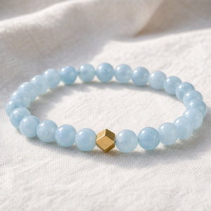Close-up of the Aquamarine 6mm Bead Bracelet with Gold Accent on white linen