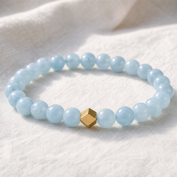 Close-up of the Aquamarine 6mm Bead Bracelet with Gold Accent on white linen