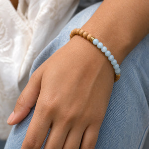 Woman wearing the Aquamarine & Rosewood 6mm Bead Bracelet with blue denim
