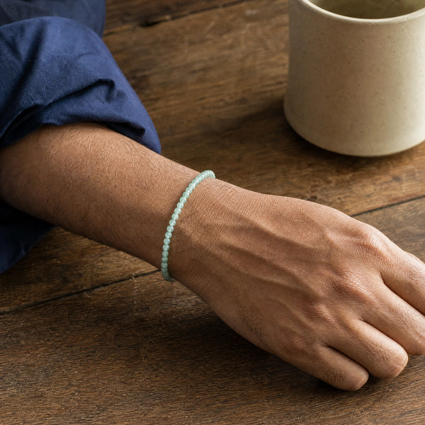 Man wearing the Aventurine 4mm Round Bead Bracelet with a navy cotton shirt