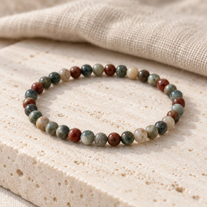 Soultheory Bloodstone 4mm Round Bead Bracelet on a travertine slab and linen