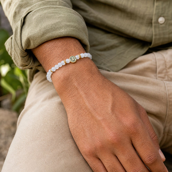 Man wearing the Chalcedony 4mm Bracelet with Om Charm with an olive linen shirt