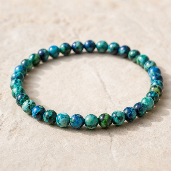 Close-up of the Chrysocolla 4mm Round Bead Bracelet on a pale stone surface