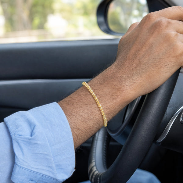 Man wearing the Citrine bracelet, while driving