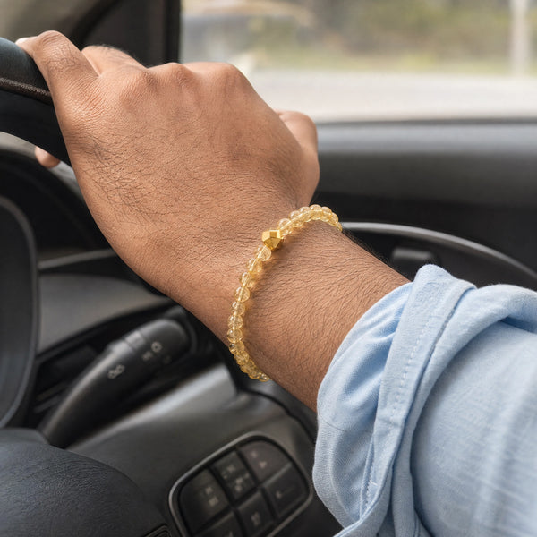 Man wearing the Citrine bracelet, while driving
