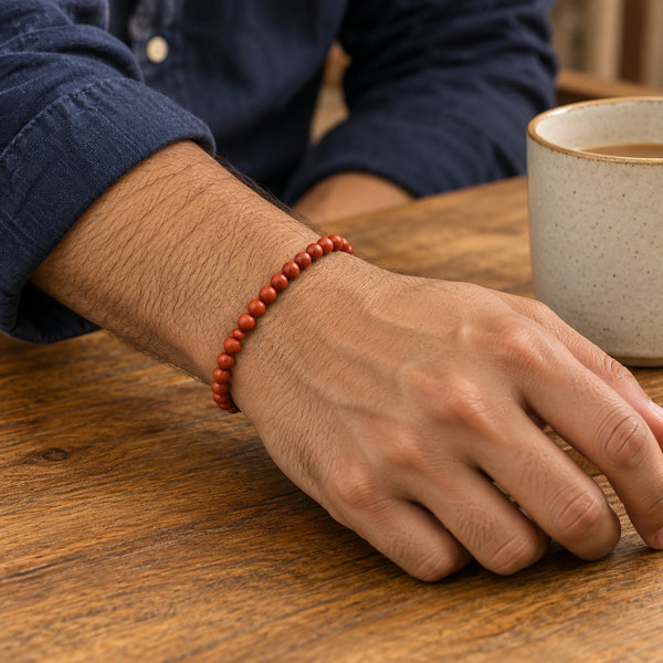 Man wearing the Goldstone 4mm Round Bead Bracelet with a navy cotton shirt