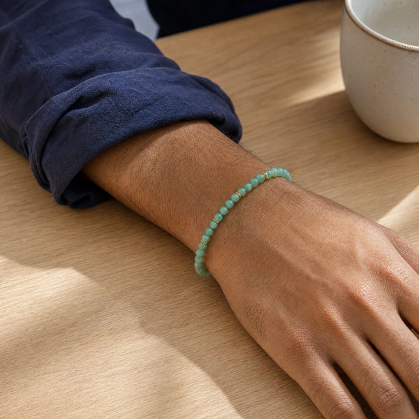 Man wearing the Green Aventurine 4mm Bead Bracelet with Gold Spacers with a navy cotton shirt