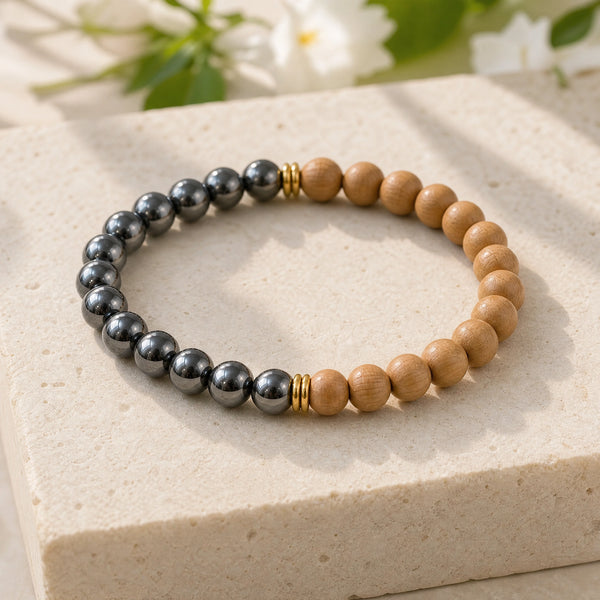 Soultheory Hematite & Rosewood 6mm Bead Bracelet on a limestone plinth with jasmine