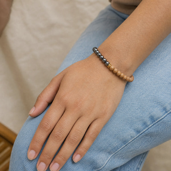 Woman wearing the Hematite & Rosewood 6mm Bead Bracelet with blue denim