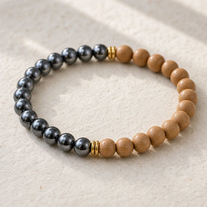 Close-up of the Hematite & Rosewood 6mm Bead Bracelet on cream handmade paper