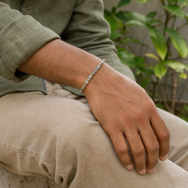 Man wearing the Labradorite 4mm Bead Bracelet with Gold Spacers with an olive linen shirt