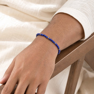 Man wearing the Lapis Lazuli 4mm Bead Bracelet with Gold Spacers with a white kurta