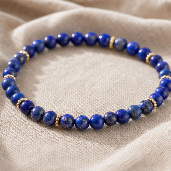 Close-up of the Lapis Lazuli 4mm Bead Bracelet with Gold Spacers on natural linen