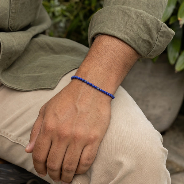 Man wearing the Lapis Lazuli 4mm Round Bead Bracelet with an olive linen shirt