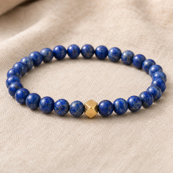 Close-up of the Lapis Lazuli 6mm Bead Bracelet with Gold Accent on natural linen