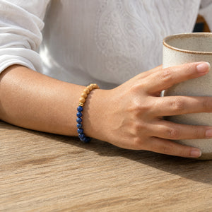Woman wearing the Lapis Lazuli bracelet, holding a ceramic coffee cup