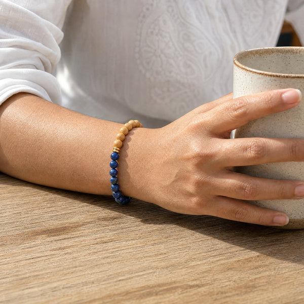 Woman wearing the Lapis Lazuli bracelet, holding a ceramic coffee cup