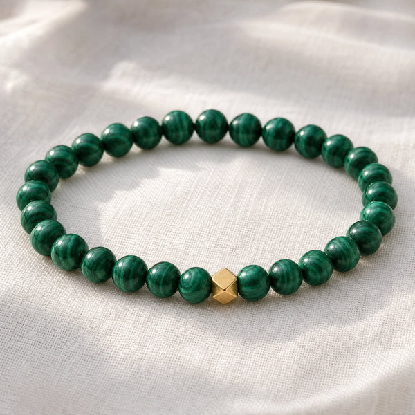 Close-up of the Malachite 6mm Bead Bracelet with Gold Accent on white linen