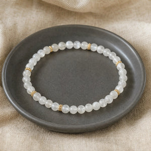 Soultheory Moonstone 4mm Bead Bracelet with Gold Spacers on a charcoal ceramic dish on linen