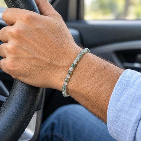 Man wearing the Moss Agate bracelet, while driving