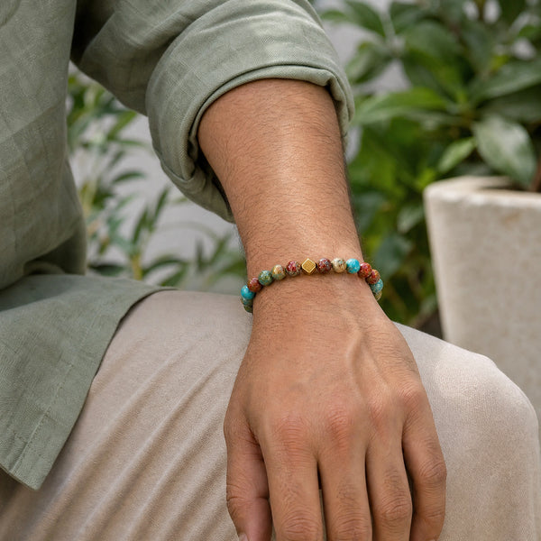 Man wearing the Multi Imperial Jasper 6mm Bead Bracelet with Gold Accent with an olive linen shirt