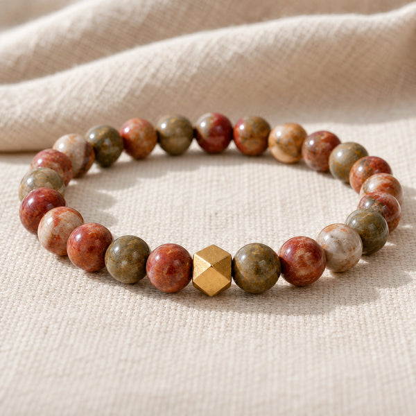 Close-up of the Picasso Jasper 6mm Bead Bracelet with Gold Accent on natural linen
