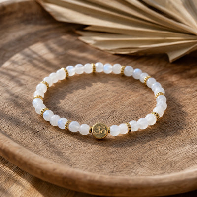 Soultheory Rainbow Moonstone 4mm Bracelet with Om Charm on a teak tray