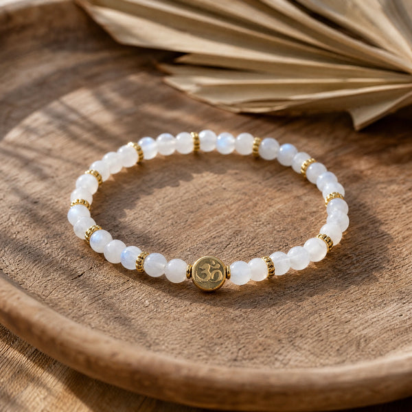 Soultheory Rainbow Moonstone 4mm Bracelet with Om Charm on a teak tray