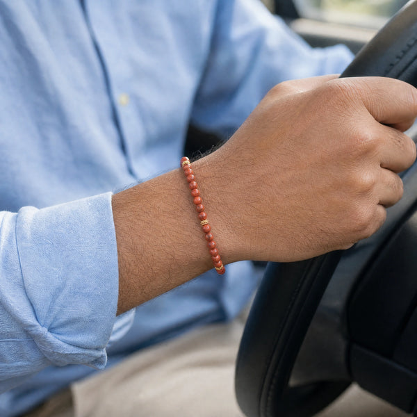 Man wearing the Red Jasper bracelet, while driving