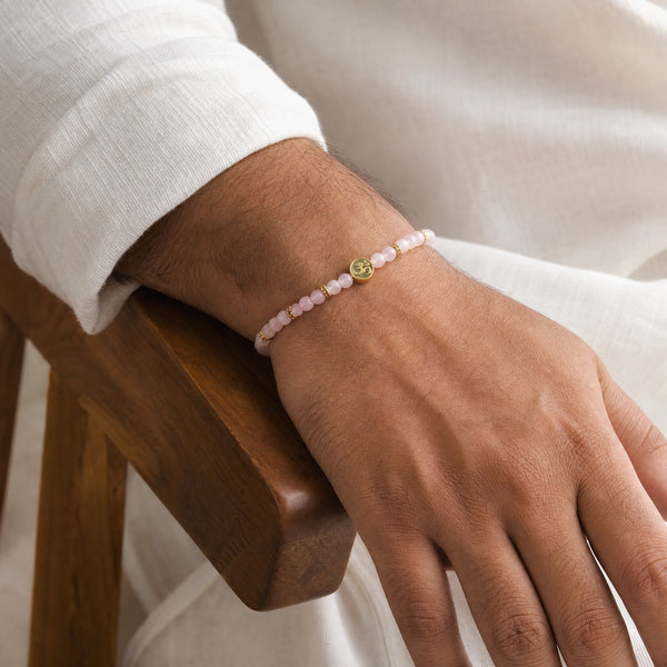 Man wearing the Rose Quartz 4mm Bracelet with Om Charm with a white kurta