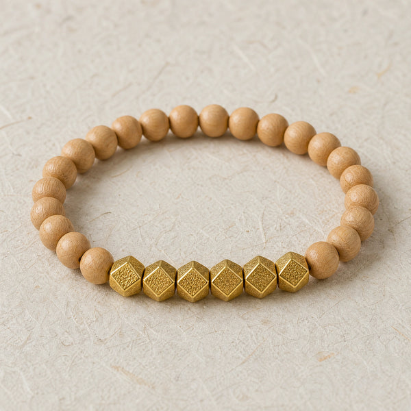 Close-up of the Rosewood 6mm Bead Bracelet with Gold Accents on cream handmade paper