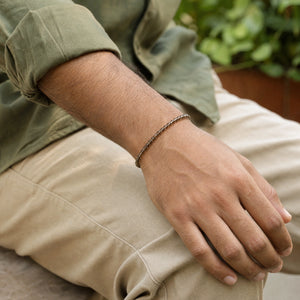 Man wearing the Smoky Quartz 4mm Round Bead Bracelet with an olive linen shirt