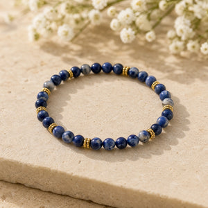 Soultheory Sodalite 4mm Bead Bracelet with Gold Spacers on a sandstone block with white flowers