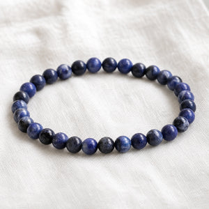 Close-up of the Sodalite 4mm Round Bead Bracelet on white linen