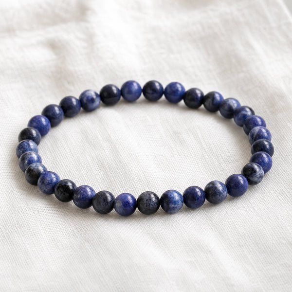 Close-up of the Sodalite 4mm Round Bead Bracelet on white linen