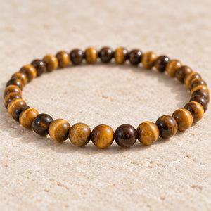 Close-up of the Tiger Eye 4mm Round Bead Bracelet on cream handmade paper