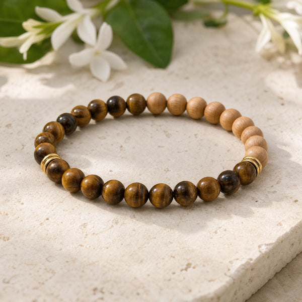 Soultheory Tiger Eye & Rosewood 6mm Bead Bracelet on a limestone plinth with jasmine