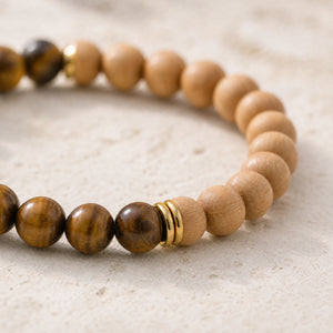 Close-up of the Tiger Eye & Rosewood 6mm Bead Bracelet on cream handmade paper