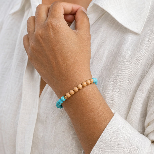 Woman wearing the Turquoise & Rosewood 6mm Bead Bracelet with a white linen shirt