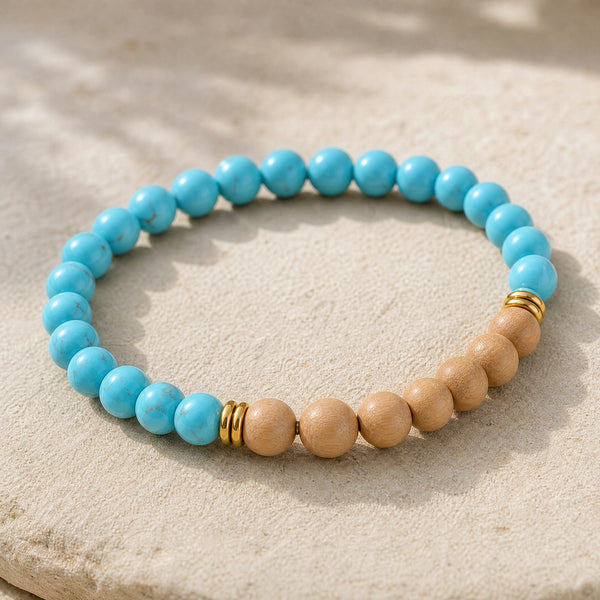 Close-up of the Turquoise & Rosewood 6mm Bead Bracelet on a pale stone surface
